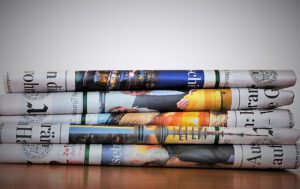 積み重ねられた新聞を使って英文ニュースを精読するイメージ